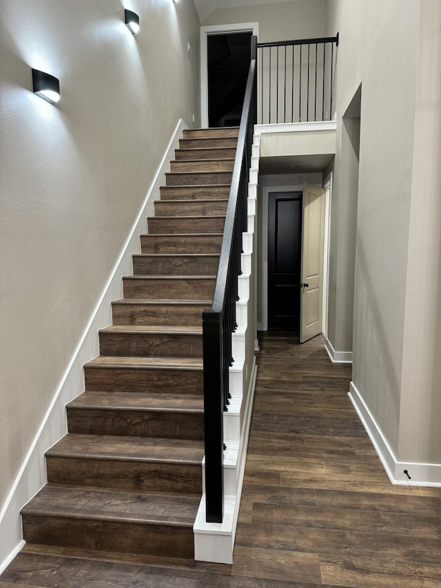 262 Rd 660, Dayton, TX 77535 - stairway featuring baseboards, wood finished floors, and a high ceiling