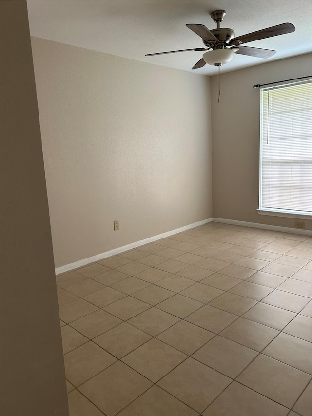 18727 Parfield Ln, Houston, TX 77084 - spare room featuring a ceiling fan, baseboards, and light tile patterned flooring