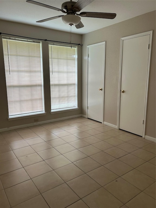 18727 Parfield Ln, Houston, TX 77084 - spare room with ceiling fan, baseboards, and light tile patterned flooring