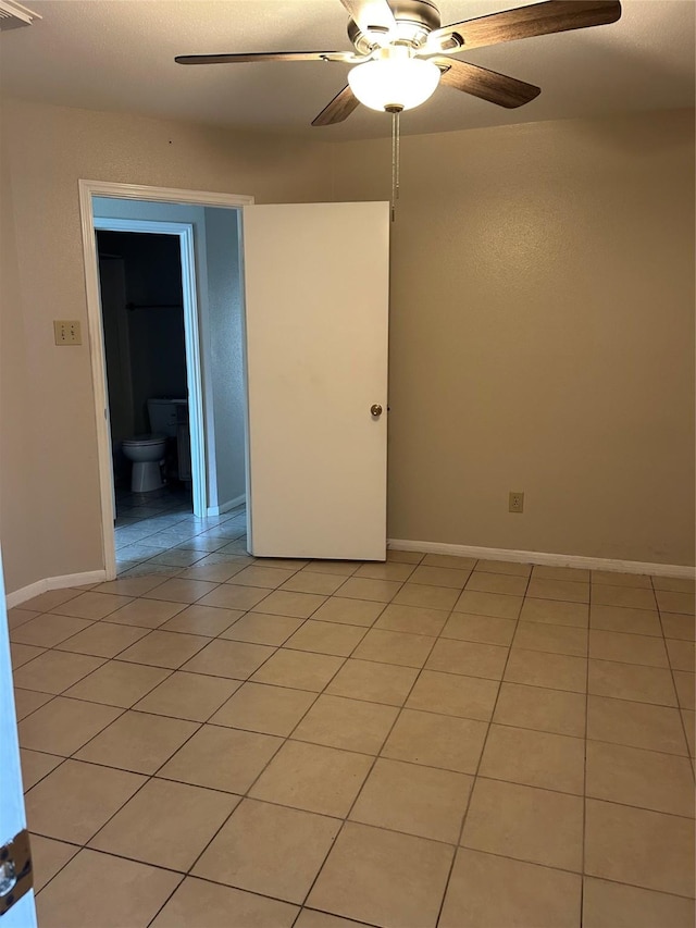 18727 Parfield Ln, Houston, TX 77084 - empty room featuring a ceiling fan, light tile patterned floors, and baseboards