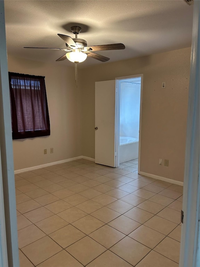 18727 Parfield Ln, Houston, TX 77084 - empty room with ceiling fan, light tile patterned floors, and baseboards