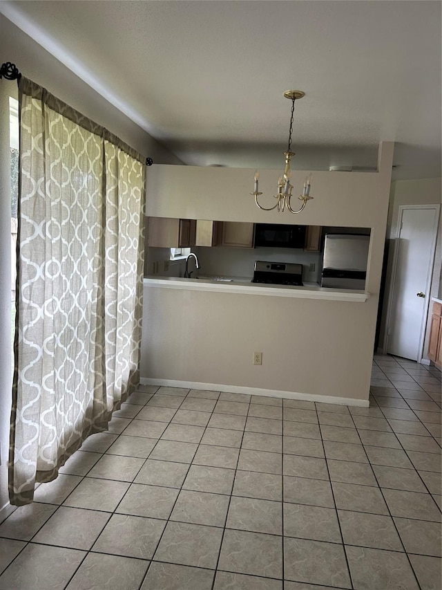 18727 Parfield Ln, Houston, TX 77084 - kitchen featuring stove, light tile patterned floors, a chandelier, black microwave, and stainless steel fridge
