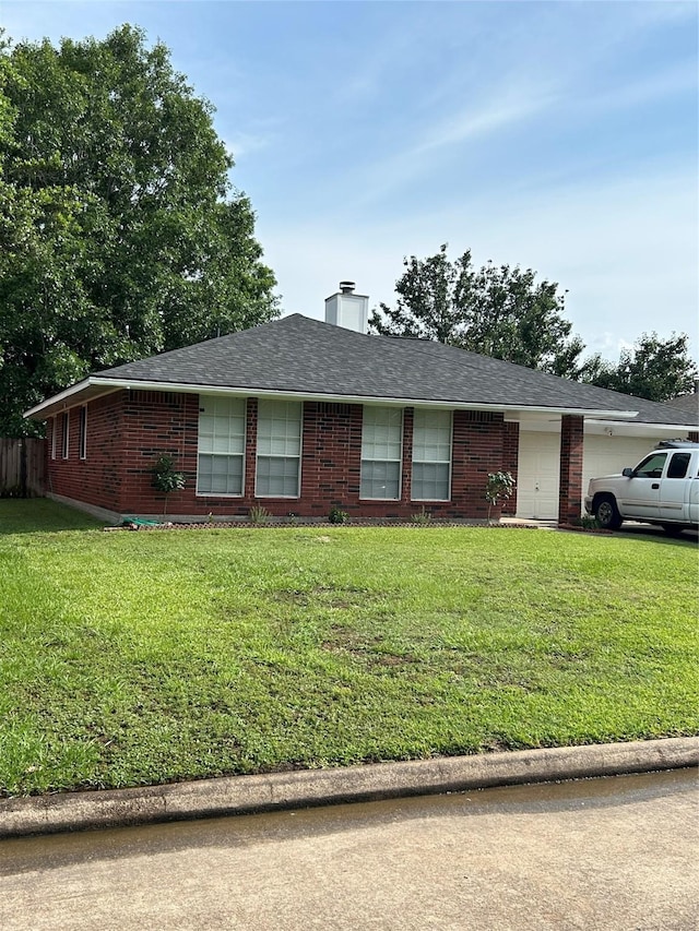 18727 Parfield Ln, Houston, TX 77084 - single story home featuring brick siding, a front yard, a chimney, and an attached garage