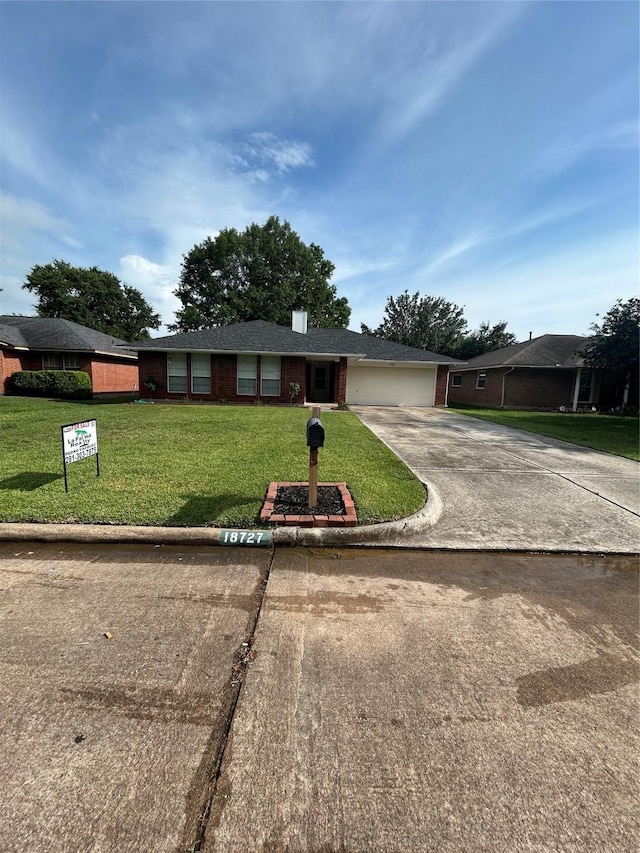 18727 Parfield Ln, Houston, TX 77084 - ranch-style home with driveway, an attached garage, a front yard, and brick siding
