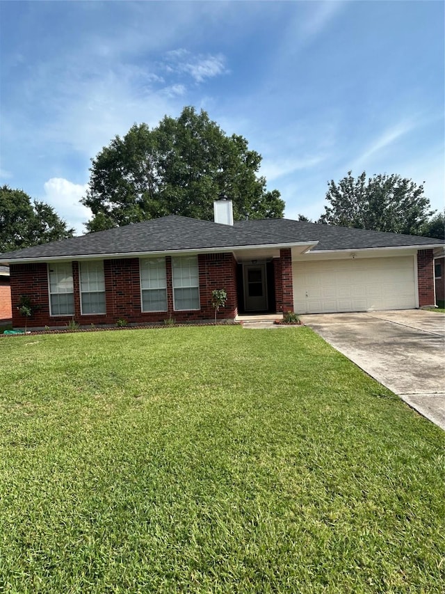 18727 Parfield Ln, Houston, TX 77084 - ranch-style house featuring concrete driveway, an attached garage, brick siding, a front yard, and a chimney