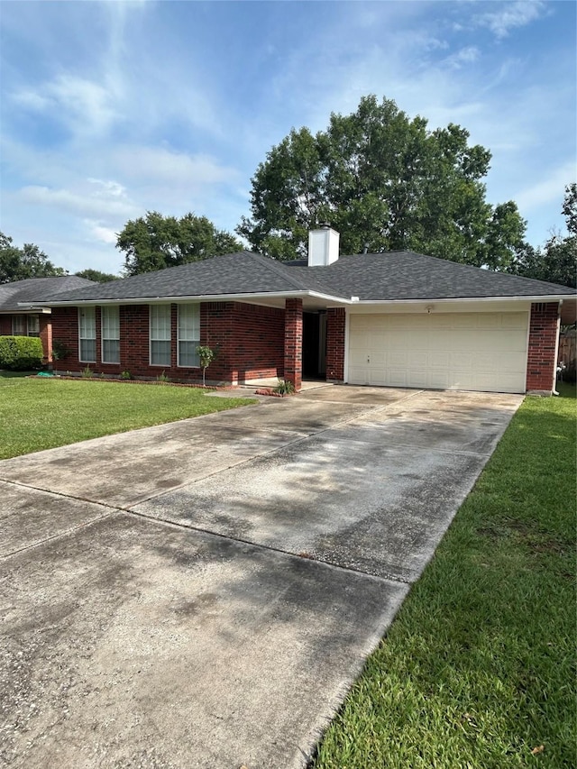 18727 Parfield Ln, Houston, TX 77084 - ranch-style home featuring driveway, an attached garage, brick siding, a chimney, and a front yard