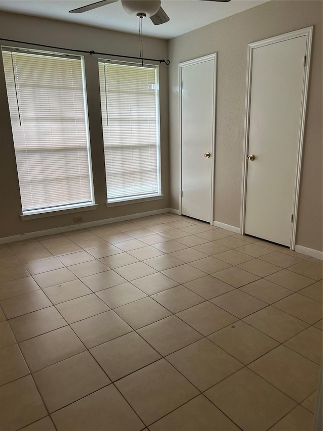 18727 Parfield Ln, Houston, TX 77084 - empty room with a ceiling fan, baseboards, and light tile patterned floors