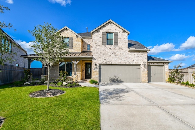 31142 Crescent Hill Dr, Fulshear, TX 77441 - view of front facade with driveway, brick siding, a shingled roof, and a standing seam roof