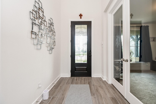 31142 Crescent Hill Dr, Fulshear, TX 77441 - foyer entrance featuring french doors, wood finish floors, and baseboards