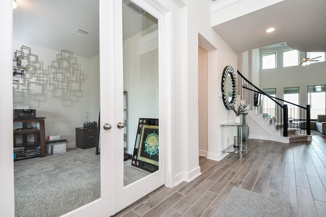 31142 Crescent Hill Dr, Fulshear, TX 77441 - foyer featuring stairway, baseboards, wood finished floors, ceiling fan, and french doors