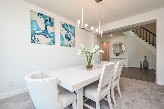 31142 Crescent Hill Dr, Fulshear, TX 77441 - carpeted dining area with baseboards, a chandelier, and stairs