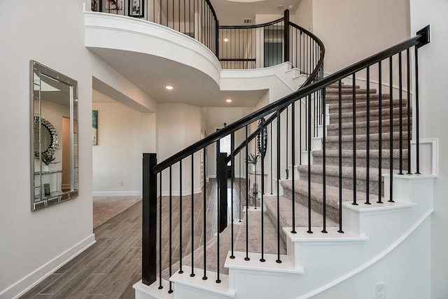31142 Crescent Hill Dr, Fulshear, TX 77441 - stairs featuring wood finished floors, a high ceiling, and baseboards