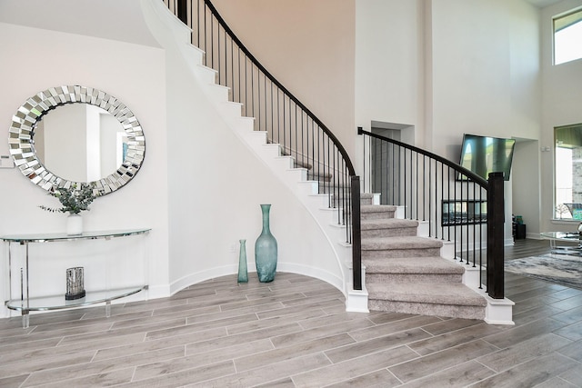 31142 Crescent Hill Dr, Fulshear, TX 77441 - staircase featuring a high ceiling, wood finished floors, and baseboards