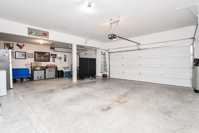 31142 Crescent Hill Dr, Fulshear, TX 77441 - garage featuring a garage door opener, freestanding refrigerator, and washer / clothes dryer