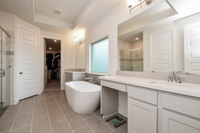 31142 Crescent Hill Dr, Fulshear, TX 77441 - bathroom with a stall shower, a walk in closet, vanity, a tray ceiling, and a freestanding tub