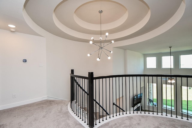 31142 Crescent Hill Dr, Fulshear, TX 77441 - hallway featuring carpet flooring, a chandelier, an upstairs landing, a tray ceiling, and baseboards