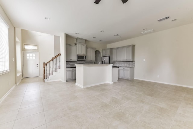 162 Cheswood Forest Pl, Montgomery, TX 77316 - kitchen featuring gray cabinets, stainless steel appliances, decorative backsplash, light tile patterned floors, and recessed lighting