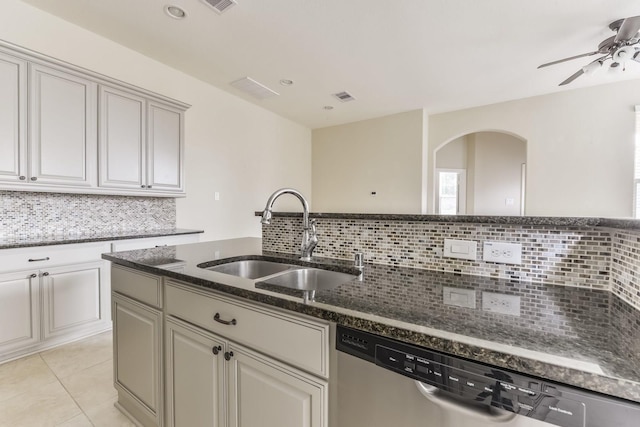 162 Cheswood Forest Pl, Montgomery, TX 77316 - kitchen featuring dishwasher, a sink, backsplash, a ceiling fan, and dark stone countertops