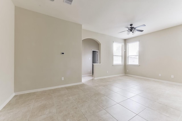 162 Cheswood Forest Pl, Montgomery, TX 77316 - spare room featuring a ceiling fan, arched walkways, light tile patterned flooring, and baseboards