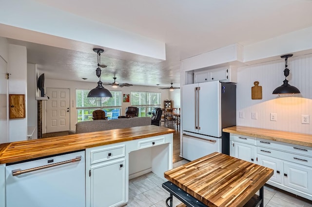131 Park Dr, Point Blank, TX 77364 - kitchen with butcher block countertops, white appliances, open floor plan, hanging light fixtures, and white cabinets