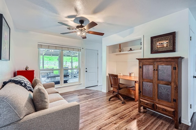 131 Park Dr, Point Blank, TX 77364 - living area featuring wood finished floors, a desk, ceiling fan, and baseboards
