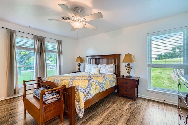 131 Park Dr, Point Blank, TX 77364 - bedroom with wood finished floors, multiple windows, and baseboards