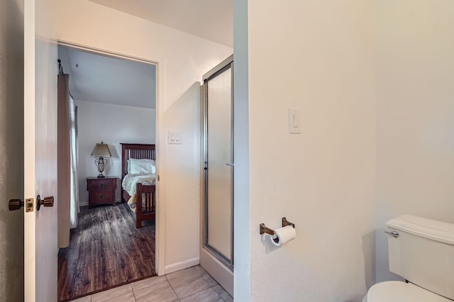 131 Park Dr, Point Blank, TX 77364 - ensuite bathroom with a shower stall, toilet, baseboards, and tile patterned floors