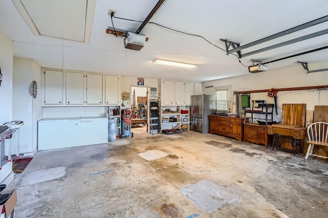 131 Park Dr, Point Blank, TX 77364 - garage featuring freestanding refrigerator and a garage door opener
