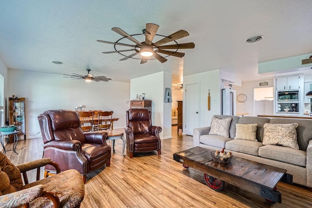 131 Park Dr, Point Blank, TX 77364 - living area featuring light wood finished floors, ceiling fan, and baseboards