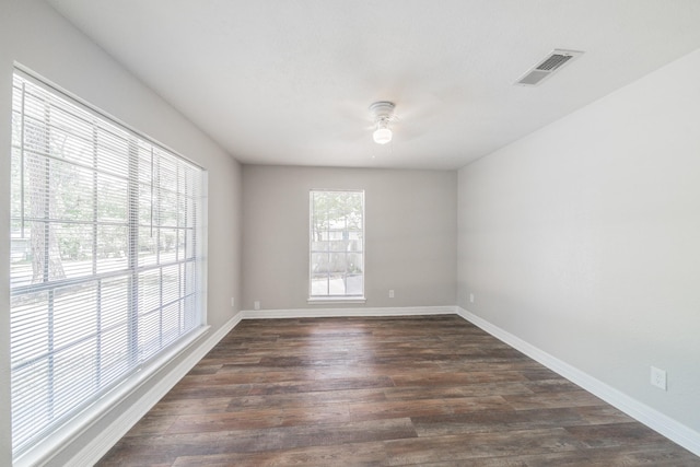 603 W Dallas St, Conroe, TX 77301 - spare room with a ceiling fan, dark wood-style floors, and baseboards