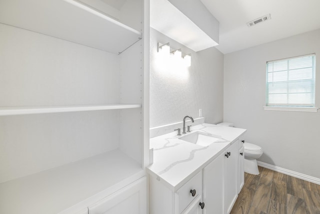 603 W Dallas St, Conroe, TX 77301 - bathroom featuring toilet, wood finished floors, vanity, and baseboards