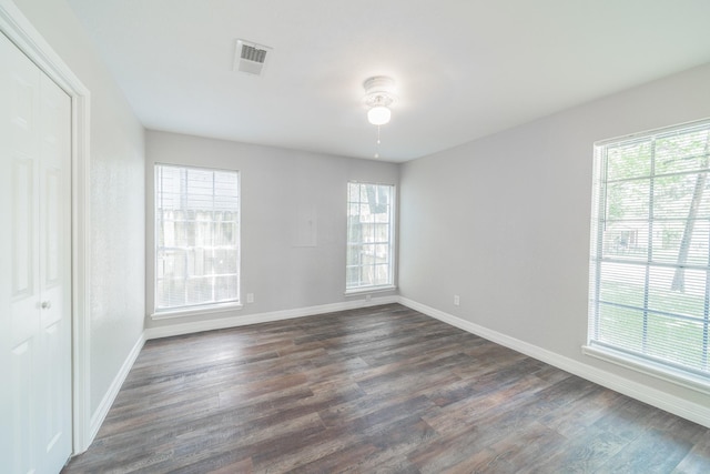 603 W Dallas St, Conroe, TX 77301 - spare room with dark wood-style floors, baseboards, and ceiling fan