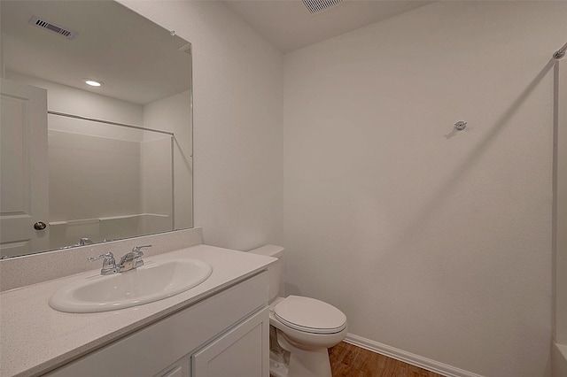 19915 Epirus Shores Dr, Hockley, TX 77447 - full bath featuring wood finished floors, toilet, vanity, baseboards, and a shower