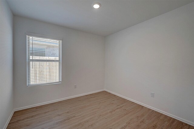 19915 Epirus Shores Dr, Hockley, TX 77447 - spare room featuring light wood finished floors, healthy amount of natural light, and baseboards
