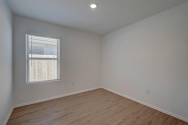 19915 Epirus Shores Dr, Hockley, TX 77447 - empty room with light wood-style floors, plenty of natural light, and baseboards