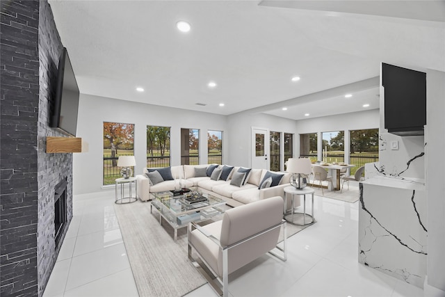 7827 Alamar Dr, Houston, TX 77095 - living area featuring light tile patterned floors, a stone fireplace, and recessed lighting