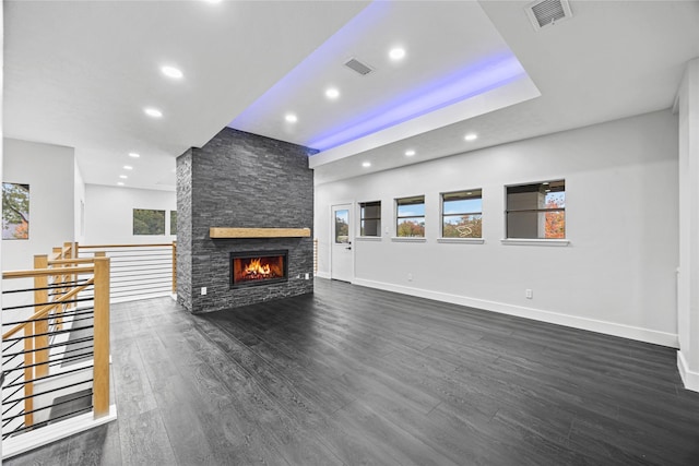 7827 Alamar Dr, Houston, TX 77095 - unfurnished living room featuring recessed lighting, dark wood-style flooring, baseboards, and a stone fireplace