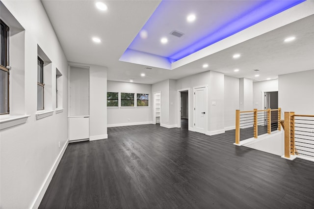 7827 Alamar Dr, Houston, TX 77095 - unfurnished living room with recessed lighting, baseboards, dark wood-style flooring, and a raised ceiling