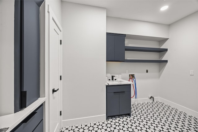 7827 Alamar Dr, Houston, TX 77095 - laundry area with cabinet space, washer hookup, hookup for an electric dryer, baseboards, and tile patterned floors