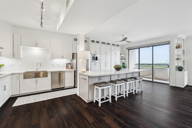 651 Bering Dr Unit 906, Houston, TX 77057 - kitchen featuring a sink, stainless steel appliances, white cabinetry, and dark wood-style flooring