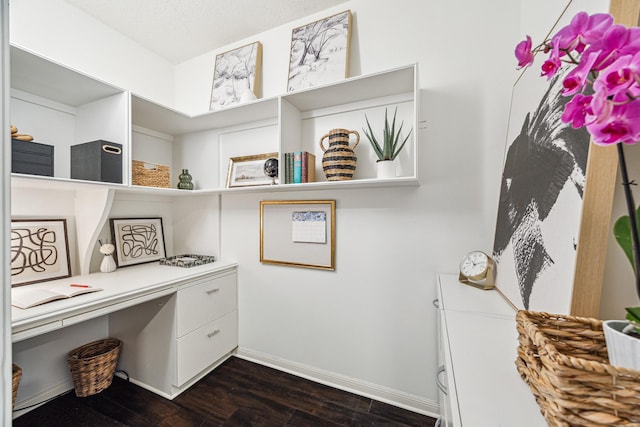 651 Bering Dr Unit 906, Houston, TX 77057 - home office featuring dark wood-style flooring, baseboards, and built in desk