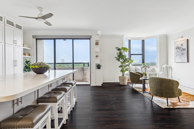 651 Bering Dr Unit 906, Houston, TX 77057 - dining room featuring crown molding, dark wood-style floors, ceiling fan, and baseboards