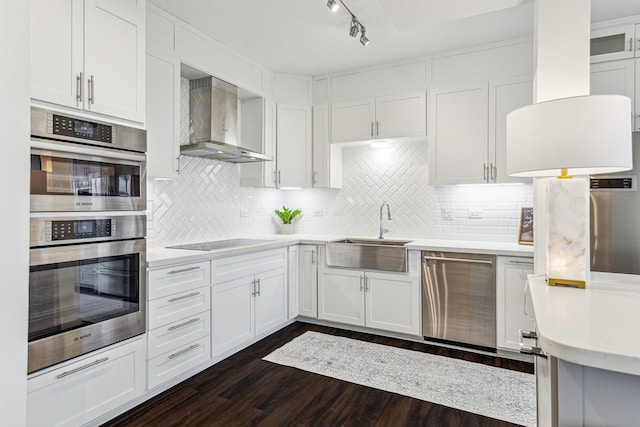 651 Bering Dr Unit 906, Houston, TX 77057 - kitchen featuring wall chimney exhaust hood, stainless steel appliances, light countertops, white cabinets, and a sink