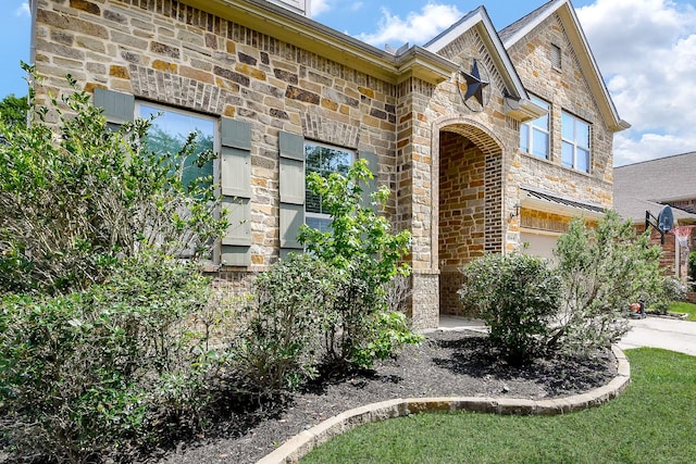 3544 Woods Estates Dr, Conroe, TX 77304 - doorway to property with stone siding, driveway, and brick siding