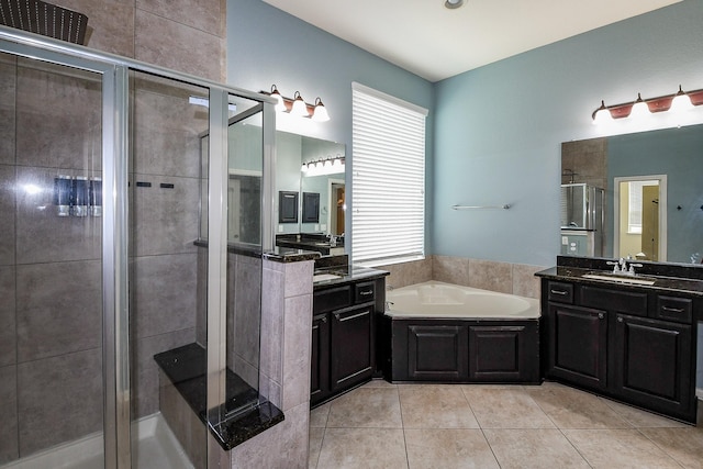 3544 Woods Estates Dr, Conroe, TX 77304 - bathroom featuring a shower stall, a bath, two vanities, and tile patterned floors