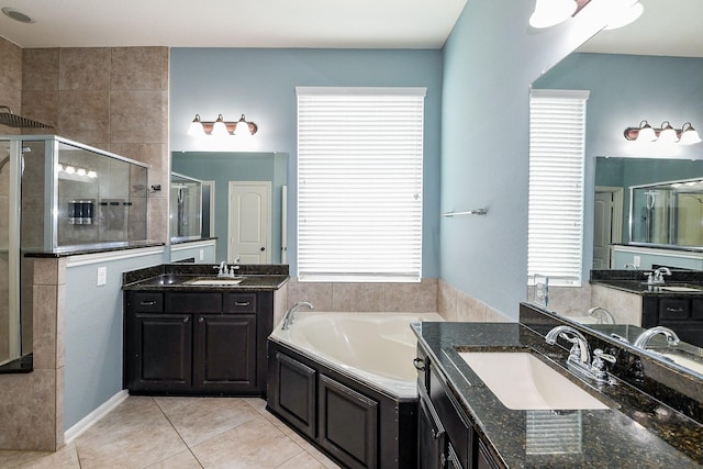 3544 Woods Estates Dr, Conroe, TX 77304 - bathroom featuring a stall shower, a garden tub, two vanities, and tile patterned flooring
