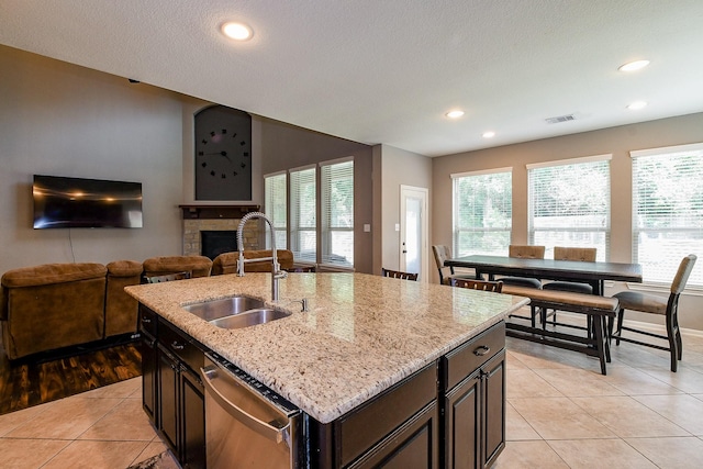 3544 Woods Estates Dr, Conroe, TX 77304 - kitchen with stainless steel dishwasher, a sink, plenty of natural light, recessed lighting, and a textured ceiling