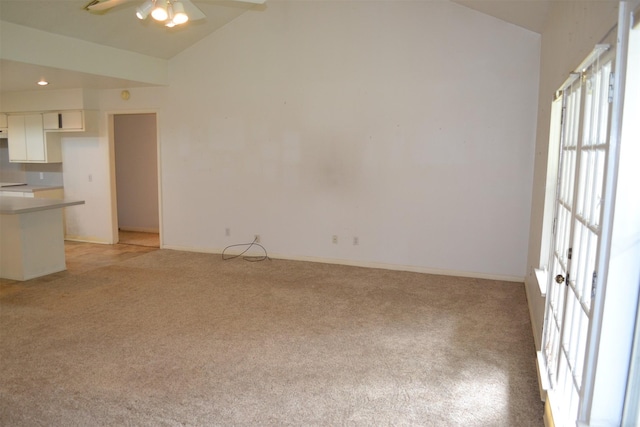 17551 W Fm 1097th Rd, Montgomery, TX 77356 - unfurnished living room featuring light carpet, a ceiling fan, high vaulted ceiling, and baseboards