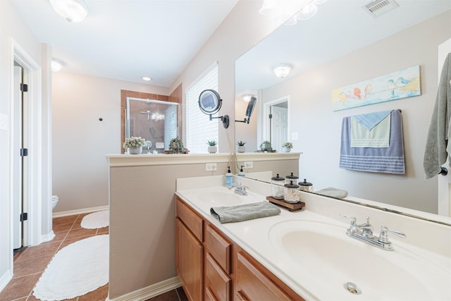 2238 Sterling Oaks Dr, Rosharon, TX 77583 - bathroom featuring a shower stall, toilet, double vanity, tile patterned flooring, and baseboards