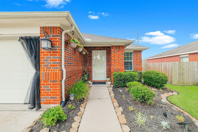 2238 Sterling Oaks Dr, Rosharon, TX 77583 - property entrance with an attached garage, brick siding, and roof with shingles